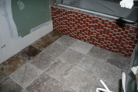 New tile floors and glass brick on front of tub