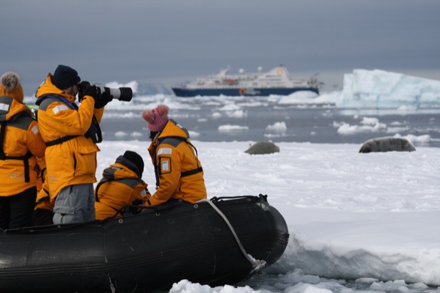 Taking photos of seals with the ship in the background