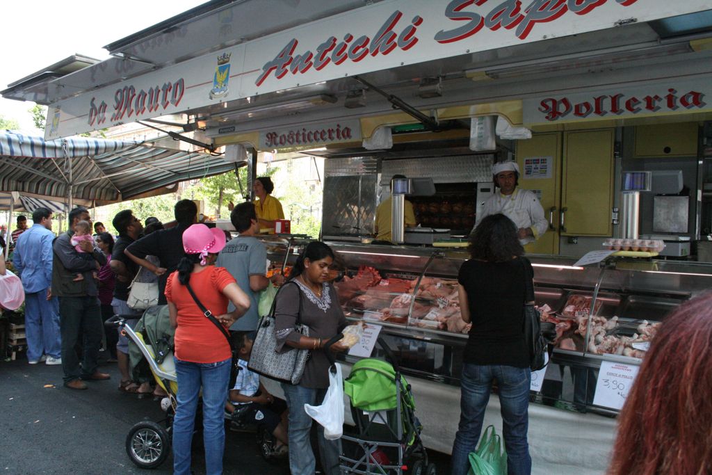 Meat cart at the outdoor market with rotisserie chicken