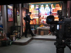 A set with a cop in front of a convenience store