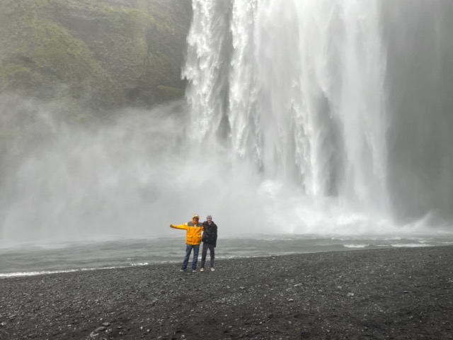 Myke and Harris getting soaked in front of the Skógafoss
